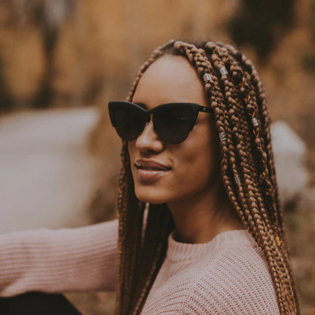 Black cat-eye sunglasses worn by model - close up