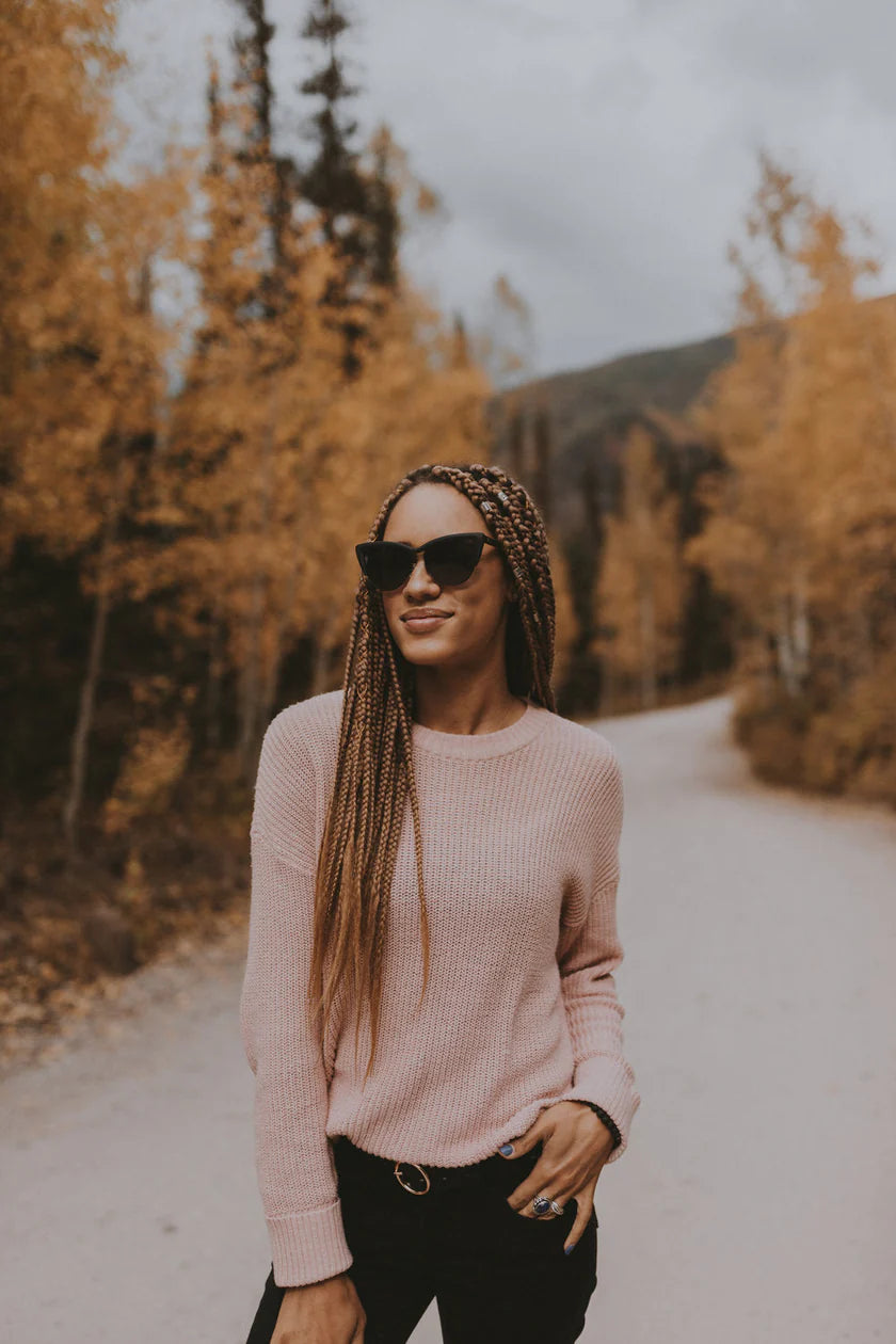 Black cat-eye sunglasses worn by model - full look outdoors